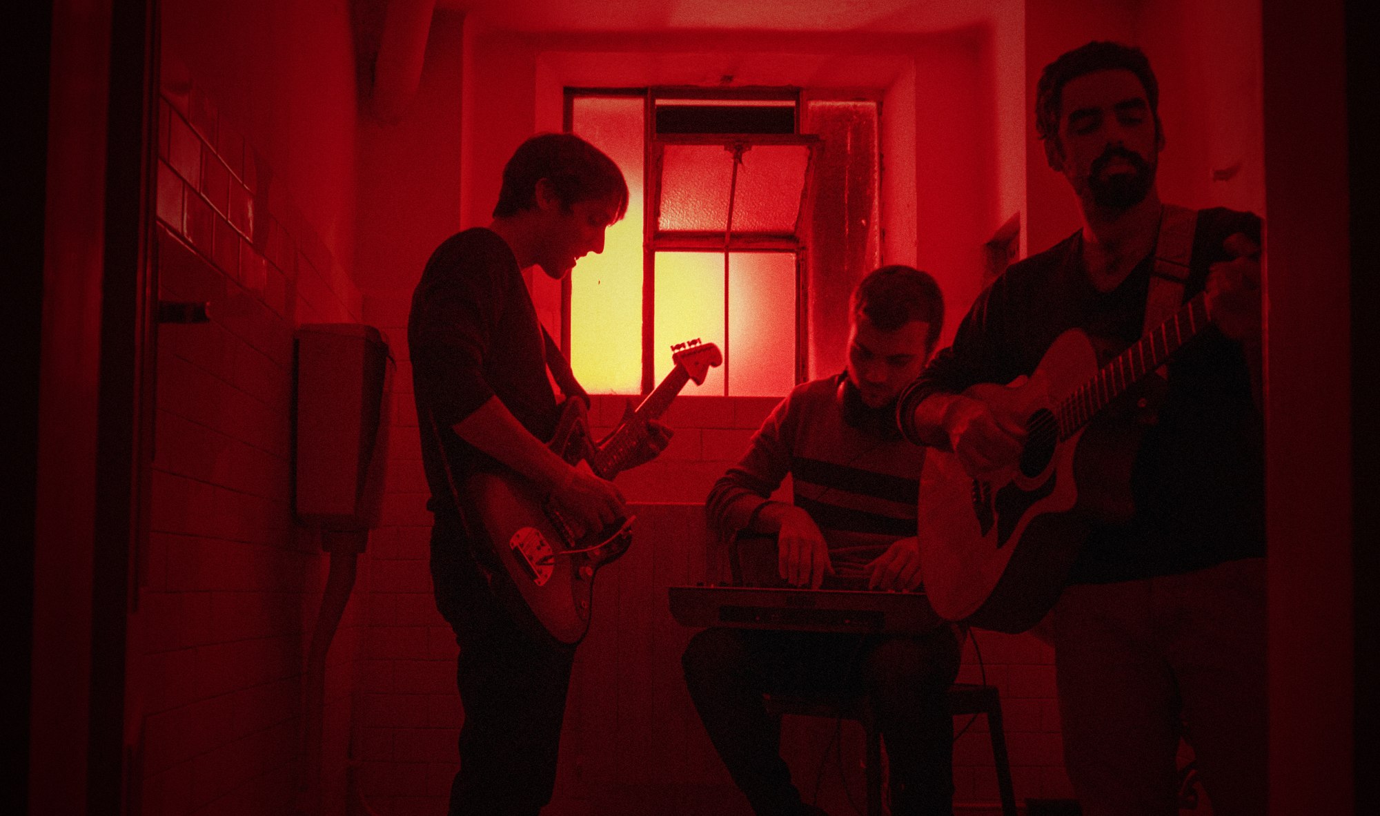 Musicisti in una stanza illuminata di rosso